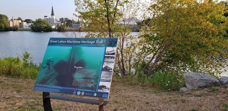 Propellers Marker (<i>wide view; Thunder Bay River and south Alpena in background</i>). Click for full size. Propellers Marker (<i>wide view; Thunder Bay River and south Alpena in background</i>) image. Click for full size.