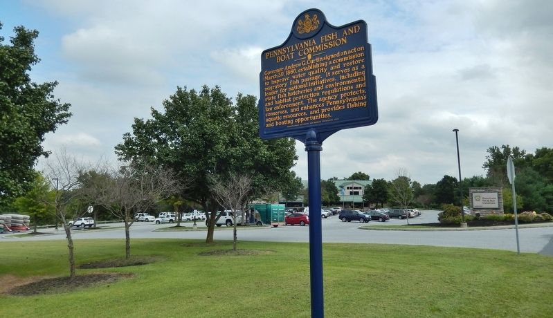 Pennsylvania Fish & Boat Commission Marker (<i>wide view; administration building in background</i>) image. Click for full size.