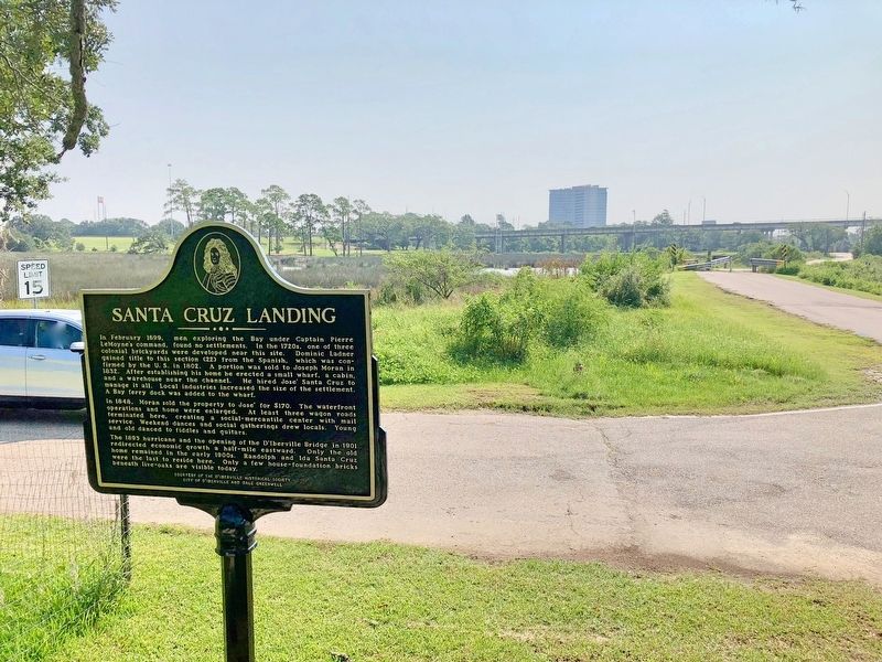 View of marker, looking east at the D'Iberville bridge over the Back Bay. image. Click for full size.