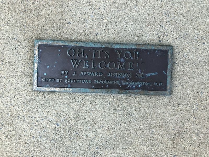 Plaque in front of statue image. Click for full size.