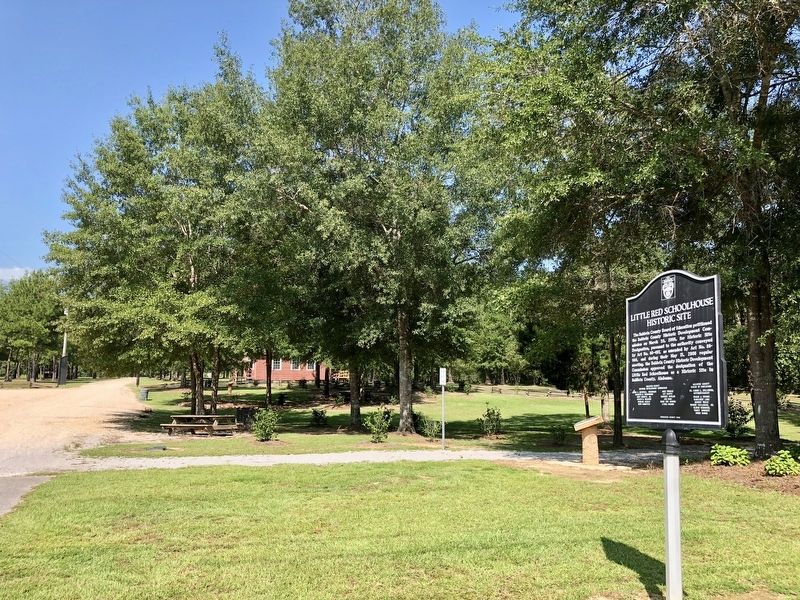 The Little Red Schoolhouse can be seen through the trees.. Click for full size. The Little Red Schoolhouse can be seen through the trees. image. Click for full size.