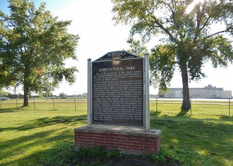 Agricultural Park Marker (<i>wide view looking east; parking lot & arena in background</i>). Click for full size. Agricultural Park Marker (<i>wide view looking east; parking lot & arena in background</i>) image. Click for full size.