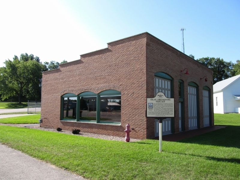 Iola’s Firefighting Heritage Marker. Click for full size. Iola’s Firefighting Heritage Marker image. Click for full size.
