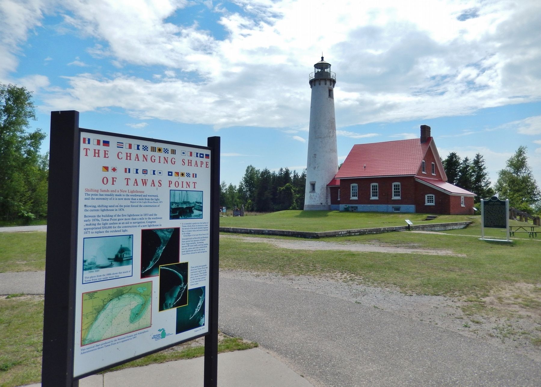 The Changing Shape of Tawas Point Marker (<i>wide view; Tawas Point Lighthouse in background</i>) image. Click for full size.