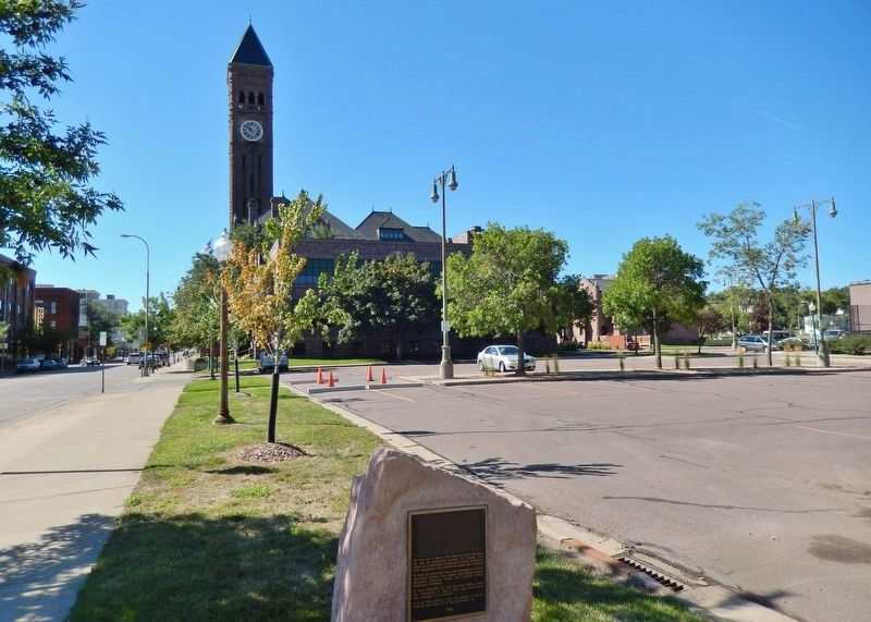 Dakota Iron Store Marker (<i>wide view; Old Minnehaha County Courthouse in background</i>) image. Click for full size.