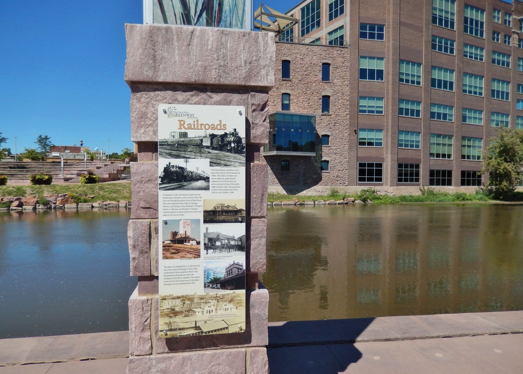 Railroads Marker (<i>wide view; Big Sioux River and Raven Industries building in background</i>) image. Click for full size.