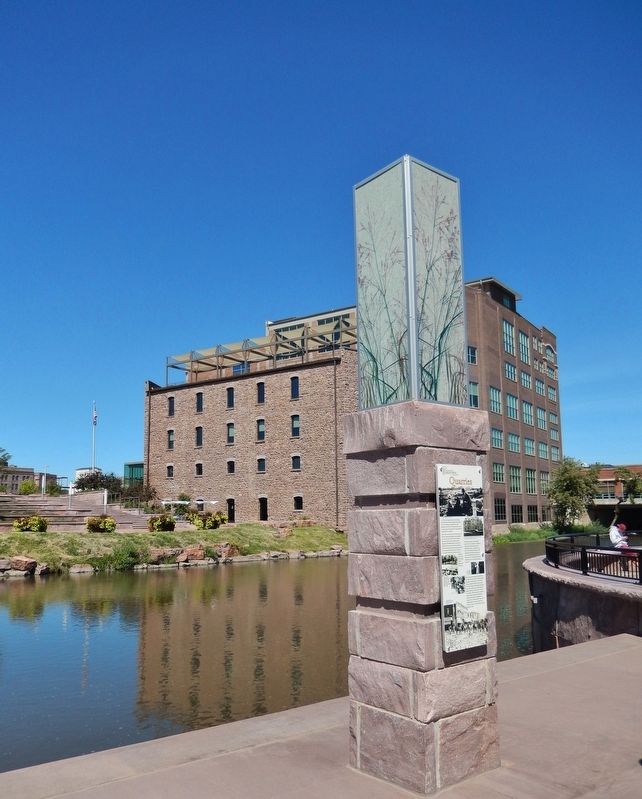 Quarries Marker (<i>tall view; Big Sioux River and Raven Industries building in background</i>) image. Click for full size.