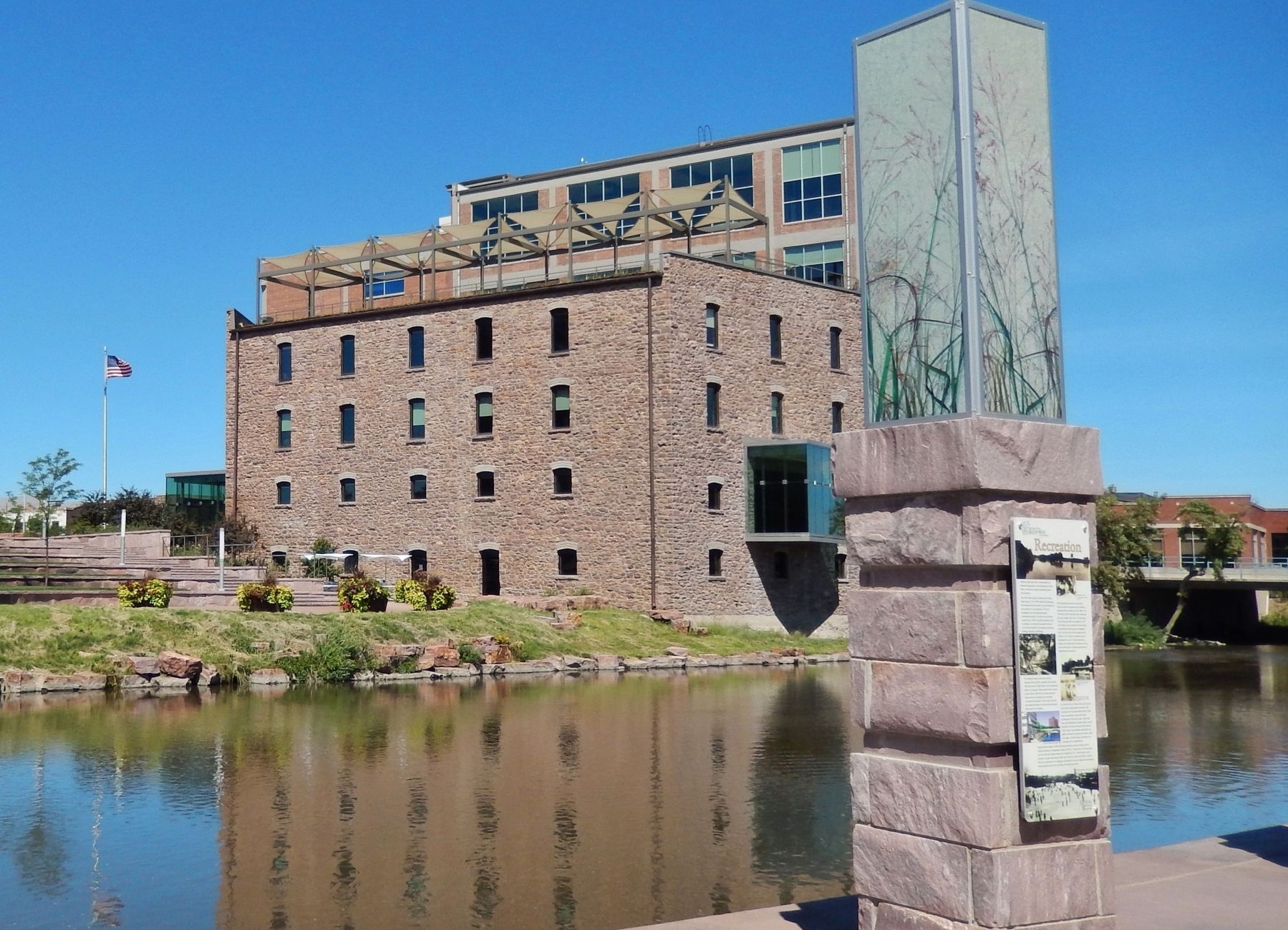 Recreation Marker (<i>wide view; Big Sioux River and Raven Industries building in background</i>). Click for full size. Recreation Marker (<i>wide view; Big Sioux River and Raven Industries building in background</i>) image. Click for full size.