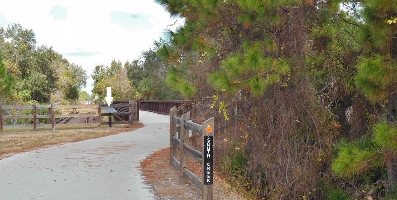 South Creek Trestle / Oscar Scherer History Marker (<i>wide view; marker/trestle left of trail</i>). Click for full size. South Creek Trestle / Oscar Scherer History Marker (<i>wide view; marker/trestle left of trail</i>) image. Click for full size.