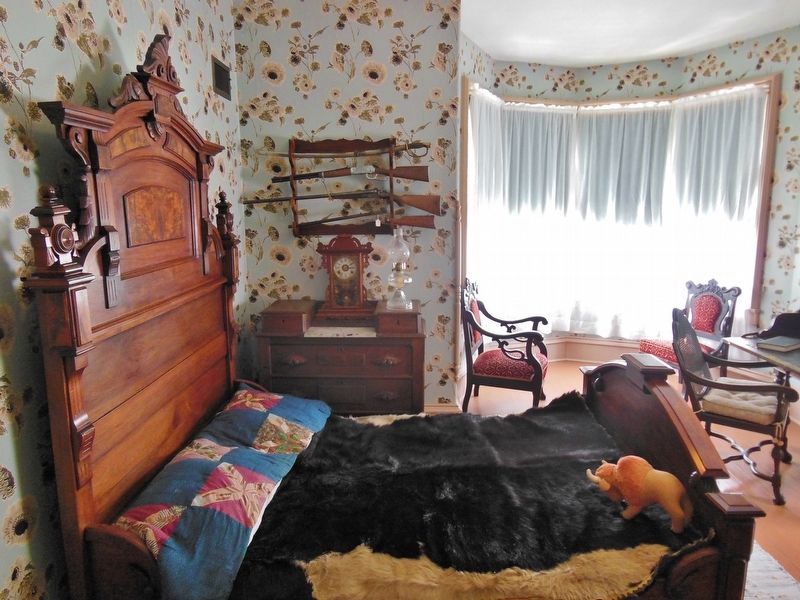 Scout's Rest Ranch: Bedroom with gun rack image. Click for full size.