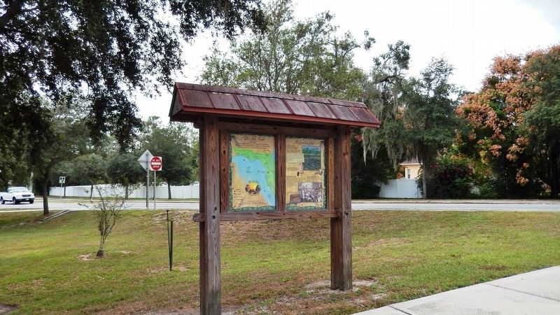 Good as Gold Marker Kiosk (<i>wide view; 7th Street/US Highway 98 visible in background</i>). Click for full size. Good as Gold Marker Kiosk (<i>wide view; 7th Street/US Highway 98 visible in background</i>) image. Click for full size.