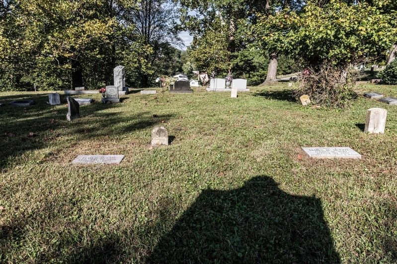 Gravesites in the shadow of the marker image. Click for full size.