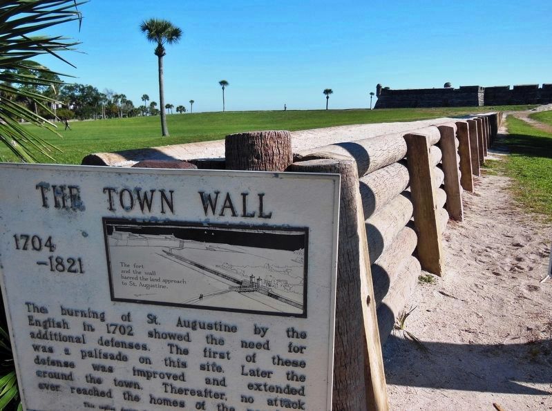 The Town Wall Marker (<i>wide view; wall replica and fort Castillo de San Marcos in background</i>) image. Click for full size.