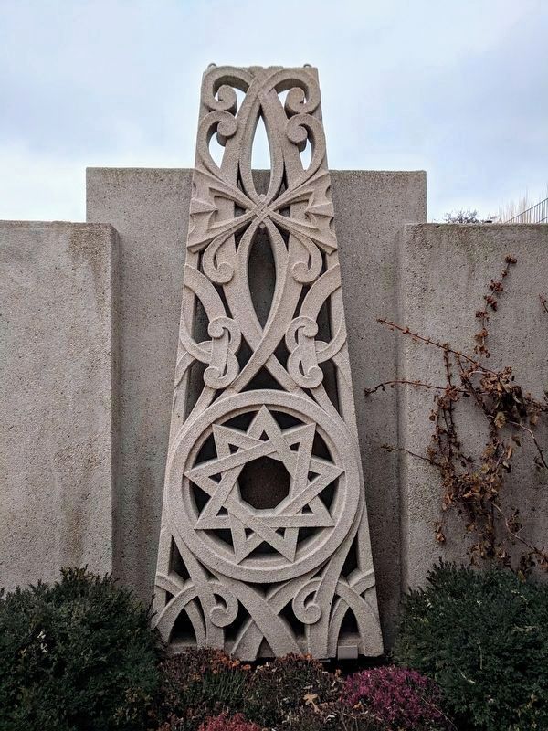Ornamental concrete structure features a nine-pointed star image. Click for full size.