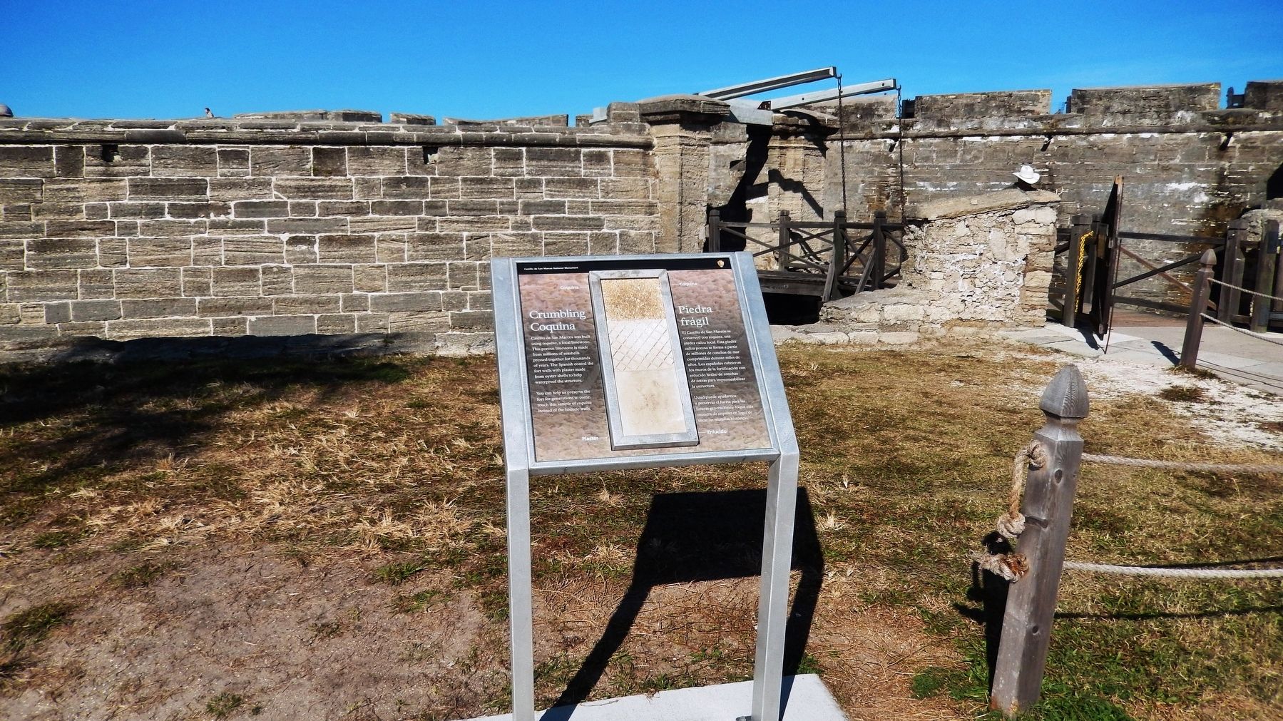 Crumbling Coquina Marker (<i>wide view; Castillo de San Marcos entrance in background</i>) image. Click for full size.