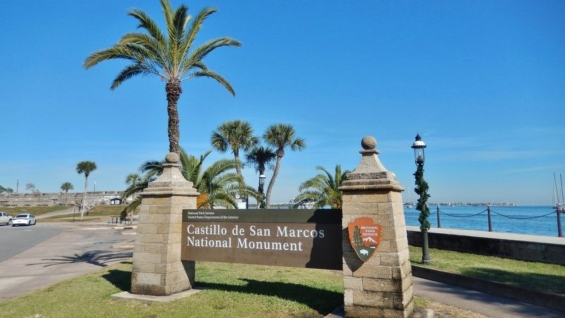 Castillo de San Marcos National Monument Sign (<i>marker located beside sidewalk; behind sign</i>) image. Click for full size.