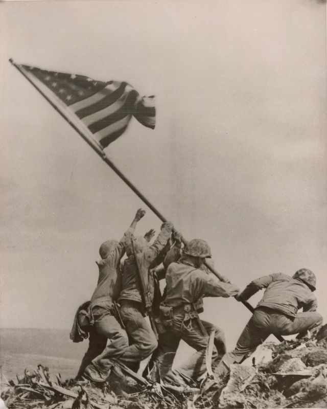 U.S. Marines [of the Fifth Division] raise the American flag on top of Mount Suribachi on Iwo Jima image. Click for full size.