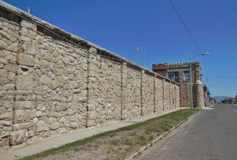 The Old Montana Prison (<i>east wall and main entrance; view north from marker along Main St.</i>) image. Click for full size.