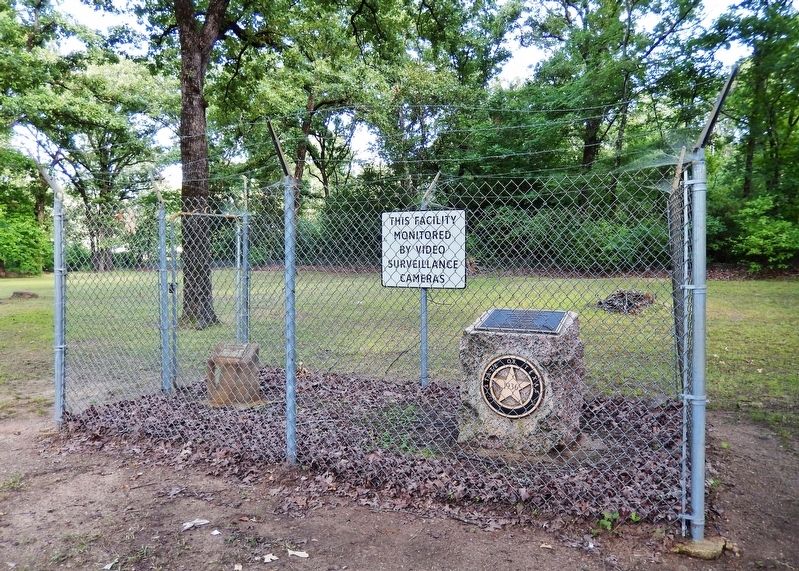 Titus County Marker (<i>wide view showing security fence surrounding marker</i>). Click for full size. Titus County Marker (<i>wide view showing security fence surrounding marker</i>) image. Click for full size.