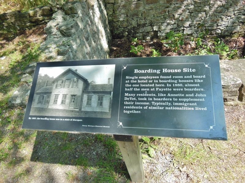 Boarding House Site Marker (<i>wide view; boarding house foundation ruins behind marker</i>) image. Click for full size.