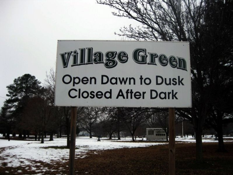 The Village Green sign with the In Honor and Memory in the distance. image. Click for full size.
