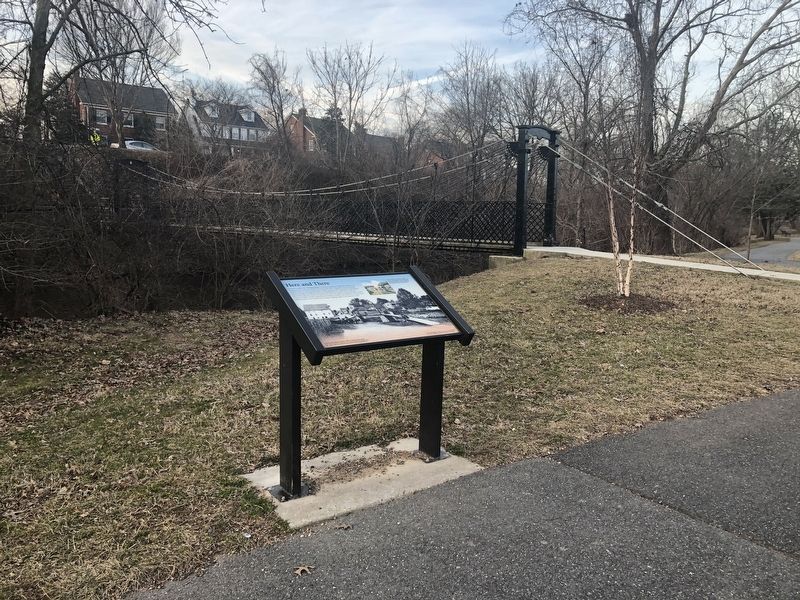 The Swinging Bridge is visible behind the marker. image. Click for full size.