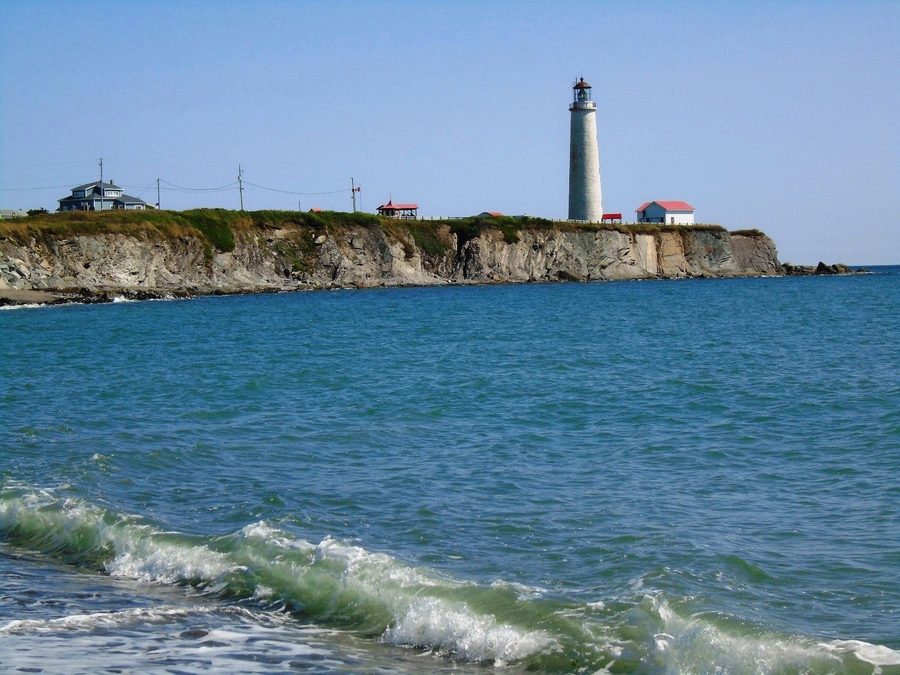 Cap-des-Rosiers Lighthouse and Rocky Coastline. Click for full size. Cap-des-Rosiers Lighthouse and Rocky Coastline image. Click for full size.