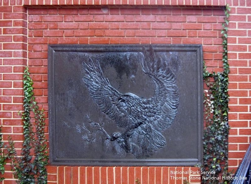 Bas relief of a bald eagle near marker. image. Click for full size.