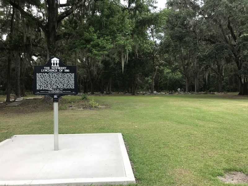 The Newberry Lynchings of 1916 Marker with cemetery behind image. Click for full size.