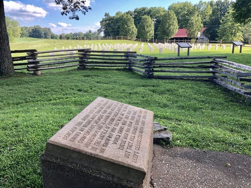 Mass grave memorial marker in foreground, marker in background. image. Click for full size.