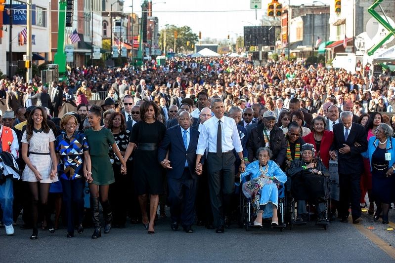 Amelia Boynton Robinson (in blue clothes in wheelchair) next to President Barack Obama. image. Click for full size.