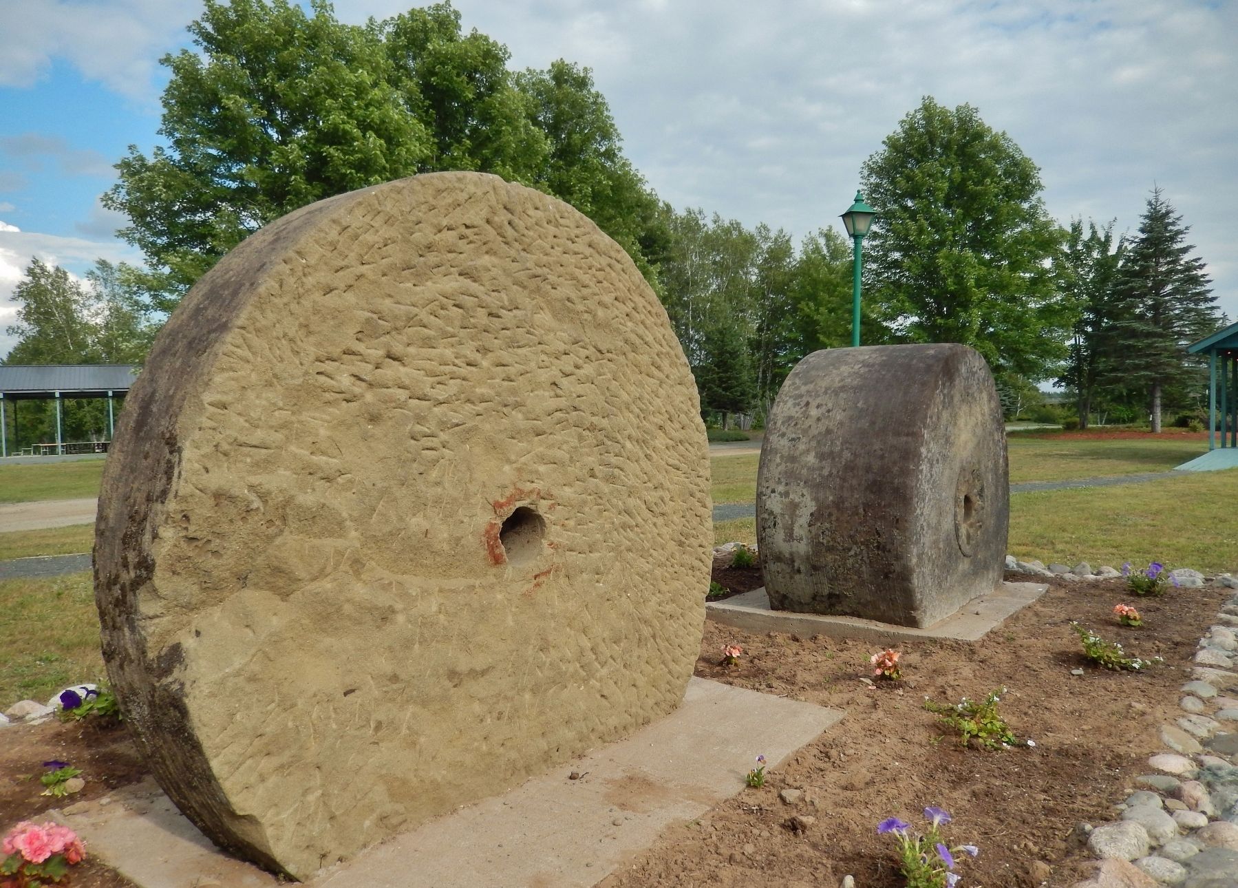 Millstones (<i>side view showing scoring and relative width</i>) image. Click for full size.