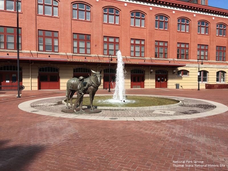 Mule and Handler Statue (foreground) and Western Maryland Train Station (background). image. Click for full size.
