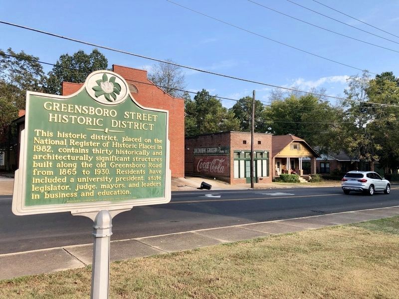 Historic District Marker with old Jr. High Grocery in background. image. Click for full size.