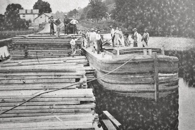 Marker detail: At Rose's Basin, workmen stack lumber in this c. 1880's photograph image. Click for full size.
