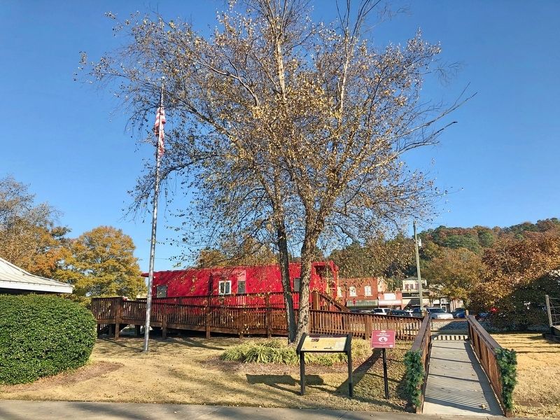 Calhoun Depot Marker looking east towards a caboose. image. Click for full size.