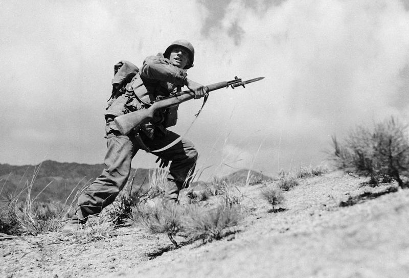 PFC John J. Allen of Company E in the 25th Infantry Division leads his men in attack. Click for full size. PFC John J. Allen of Company E in the 25th Infantry Division leads his men in attack image. Click for full size.