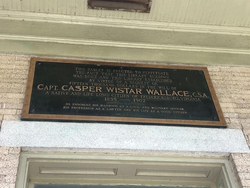 Dedication plaque above the entryway image. Click for full size.