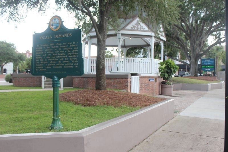 Ocala Demands Marker with Old Courthouse Square marker in far background looking west. Click for full size. Ocala Demands Marker with Old Courthouse Square marker in far background looking west image. Click for full size.