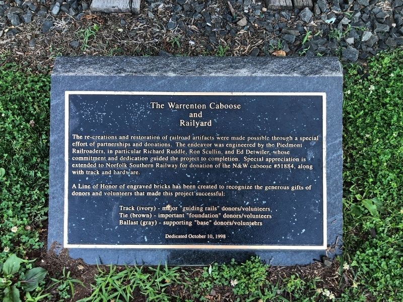 Dedication plaque in front of the caboose image. Click for full size.