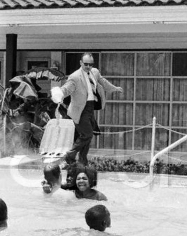 Monson Motel Manager James Brock pouring acid into motels pool image. Click for full size.
