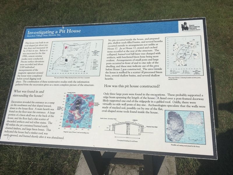 Investigating a Pit House Marker image. Click for full size.
