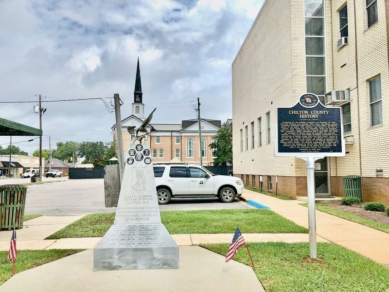 View of marker next to Courthouse with First Baptist Church in background. image. Click for full size.