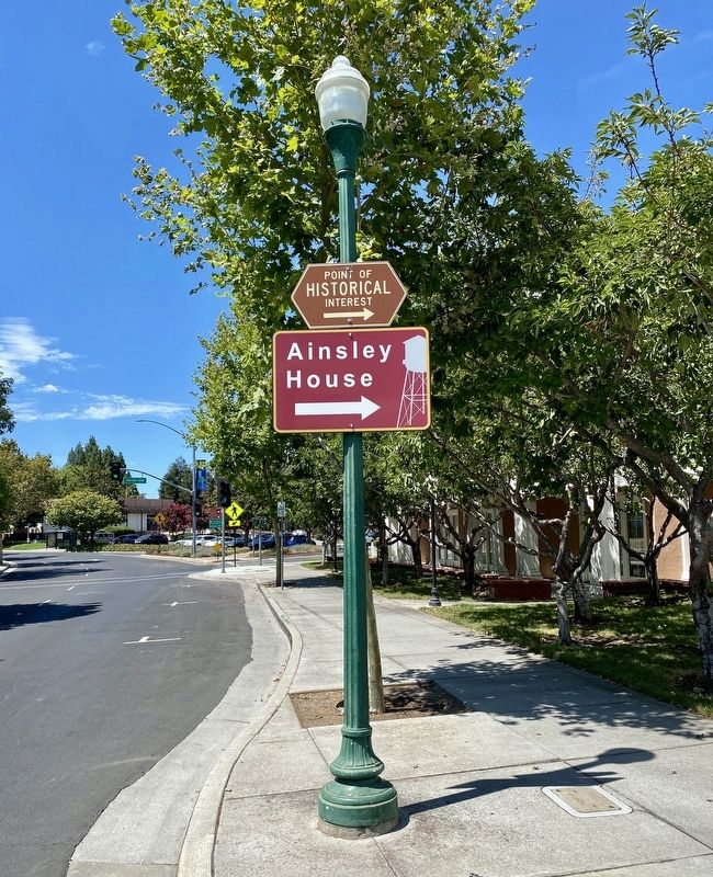 Ainsley House signs on Civic Center Drive, just north of the railroad tracks image. Click for full size.