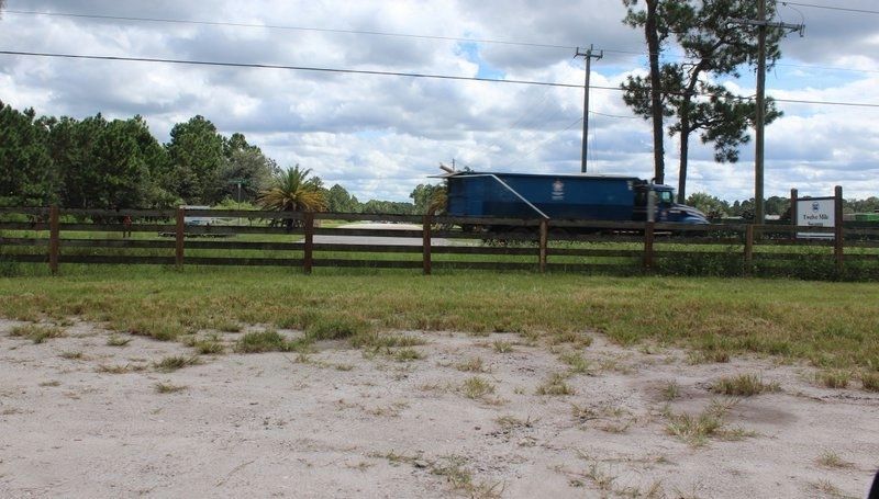 Nine Mile Road Marker's former location was to the left of the sign for Twelve Mile Swamp. Click for full size. Nine Mile Road Marker's former location was to the left of the sign for Twelve Mile Swamp image. Click for full size.