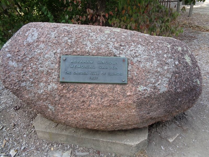 Plaque on rock image. Click for full size.