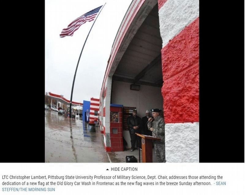 "Group dedicates large flag at car wash" image. Click for full size.