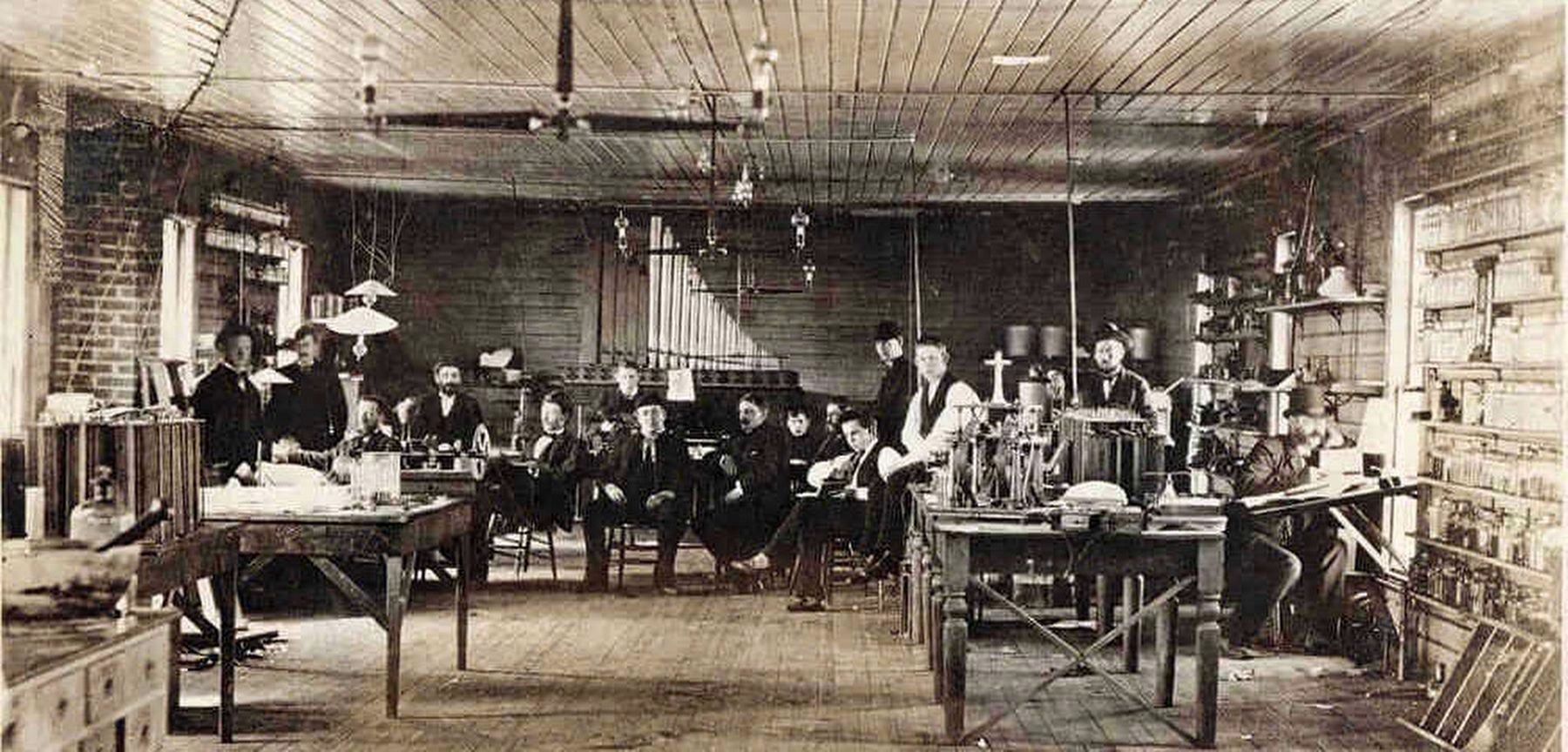 February 1880- Edison (seated center) and his Experimental Staff image. Click for full size.