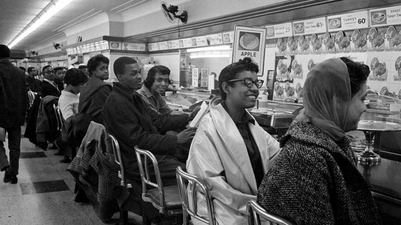 Students sit at a lunch counter as part of the Nashville Sit-in movement. image. Click for full size.