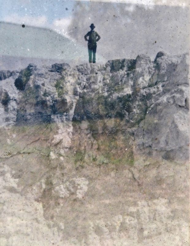 Marker detail: Man standing atop the edge of a limestone mine in nearby Suwannee County image. Click for full size.